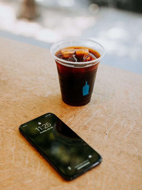 Take a Breather Glass of Coke and smart phone on a table