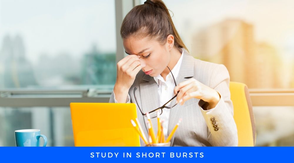 Short Burst Women with Glasses sitting on a chair infront of laptop